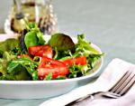American A Salad of Arugula rocket Cherry Tomatoes and Sesame Seed Appetizer