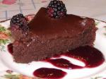American Decadent Chocolate Cake on a Bed of Raspberry Sauce Dessert