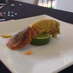 Dutch Tail of Lobster Curry Stuffed with Sausage on Its Green Lemon Appetizer