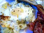 American Baked Eggs on a Bed of Potatoes With Bacon Appetizer