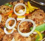 Australian Pork Chops Garnished With Peppers  Onions Appetizer